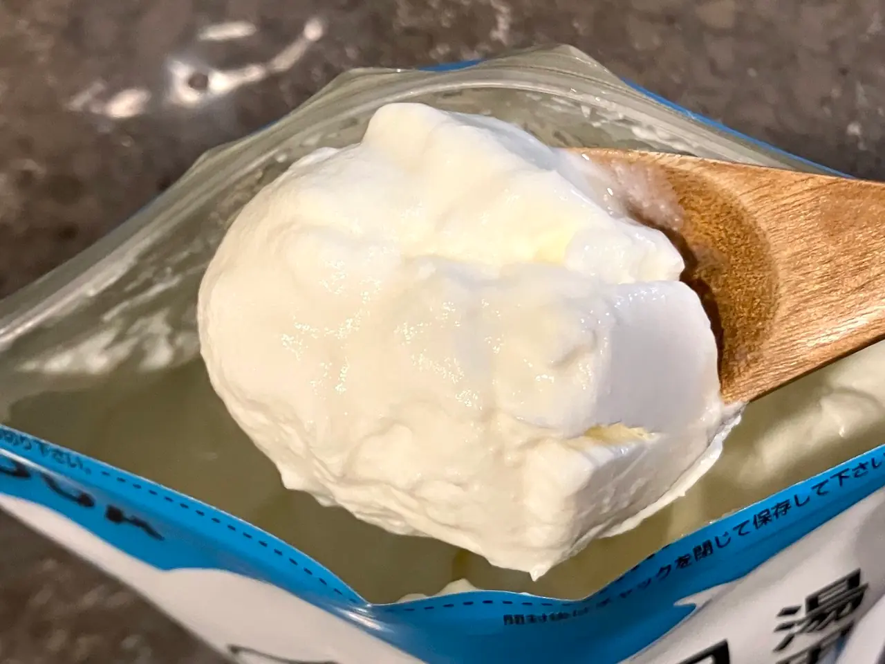 湯田ヨーグルト（プレーン味）をスプーンですくっている写真